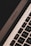 A close-up view of a MacBook Air keyboard showing the keys and part of the trackpad. The angle emphasizes the device's sleek design and modern aesthetics, with the MacBook Air logo visible.