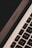 A close-up view of a MacBook Air keyboard showing the keys and part of the trackpad. The angle emphasizes the device's sleek design and modern aesthetics, with the MacBook Air logo visible.