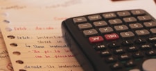 a calculator sitting on top of a piece of paper