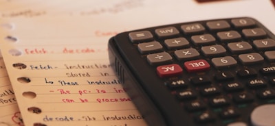 a calculator sitting on top of a piece of paper