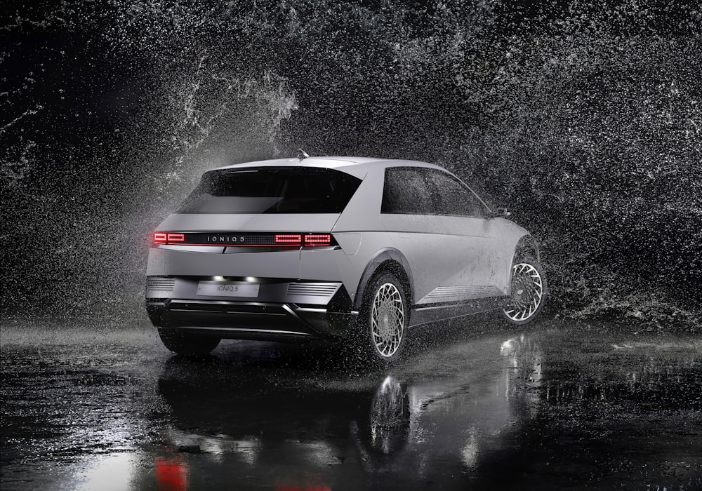 a white volkswagen suv driving through a rain storm