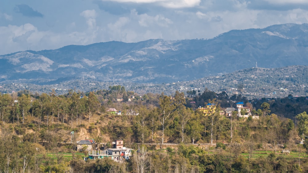 a view of a mountain range with houses in the foreground