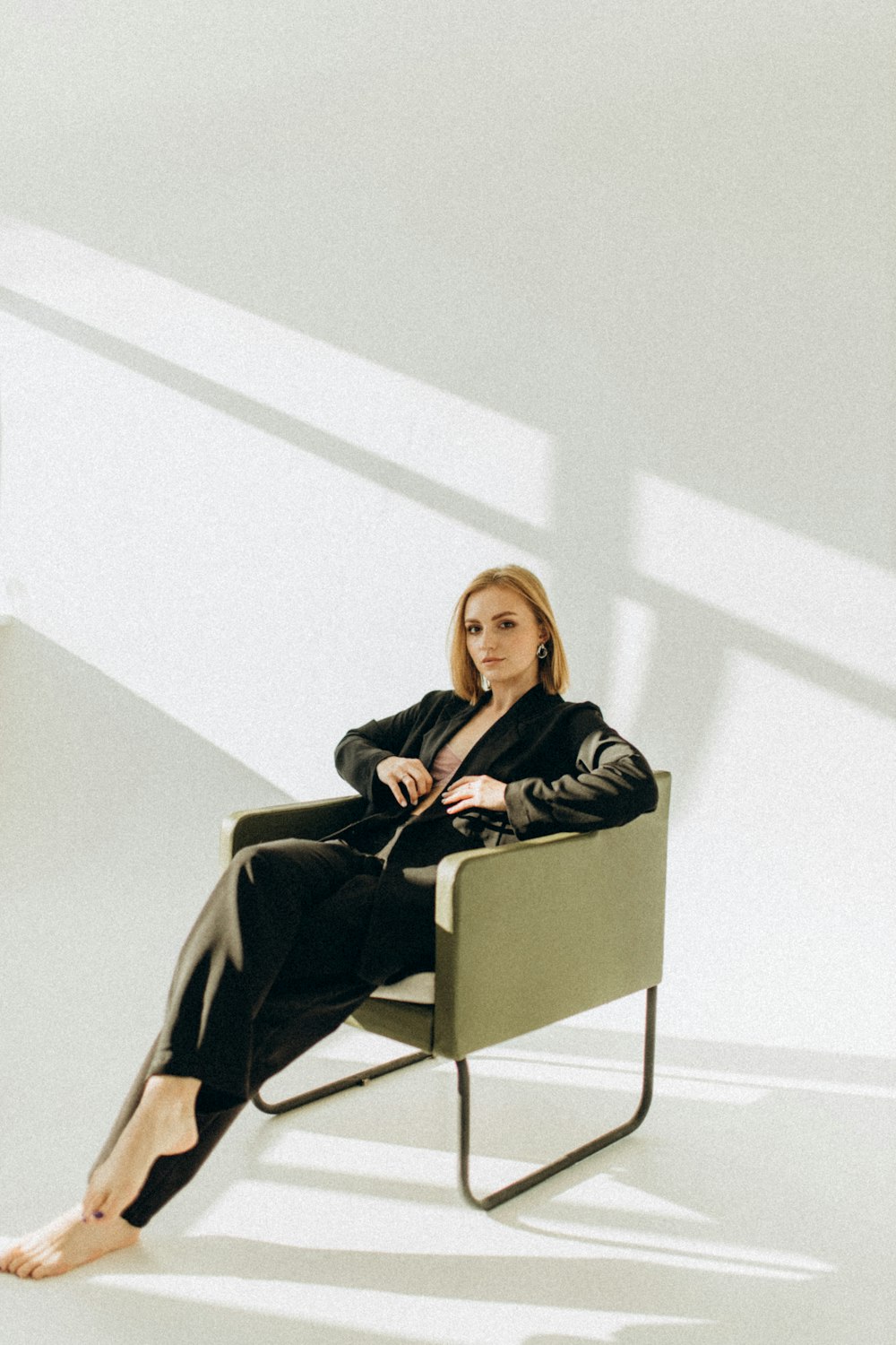 a woman sitting in a chair with her legs crossed