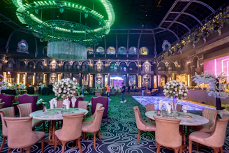 a fancy dining room with chandeliers and tables