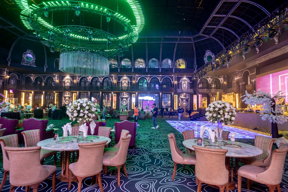 a fancy dining room with chandeliers and tables