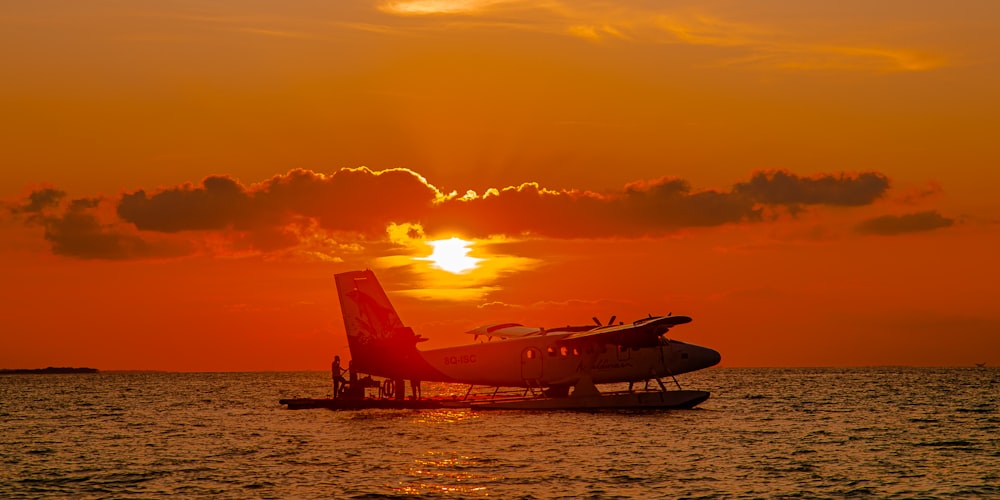 a small plane flying over a body of water