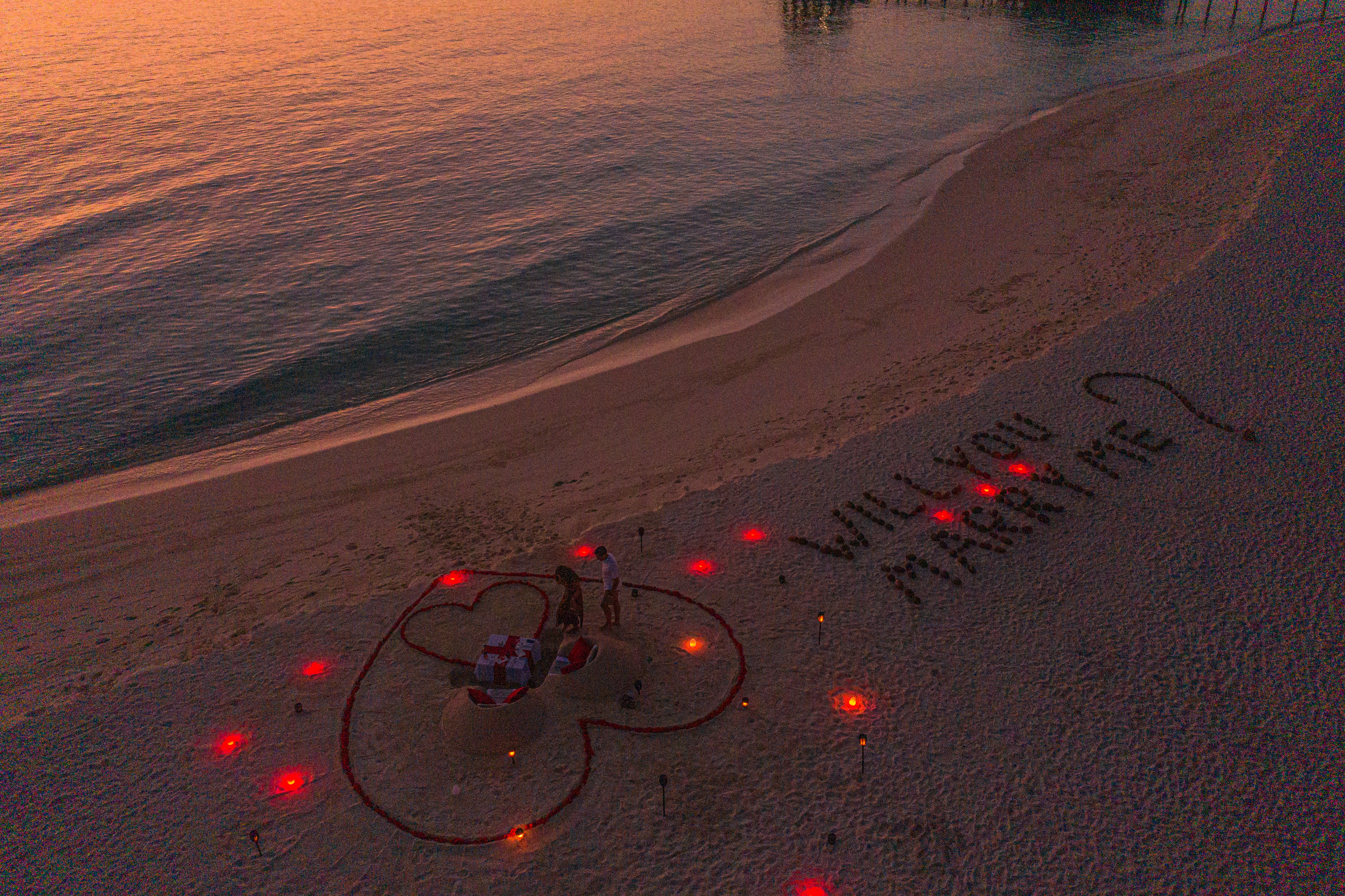 a beach with a message written in the sand