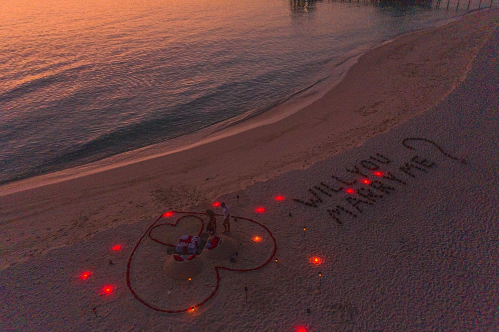a beach with a message written in the sand