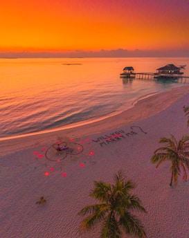 A picturesque beach setup for a proposal at sunset.