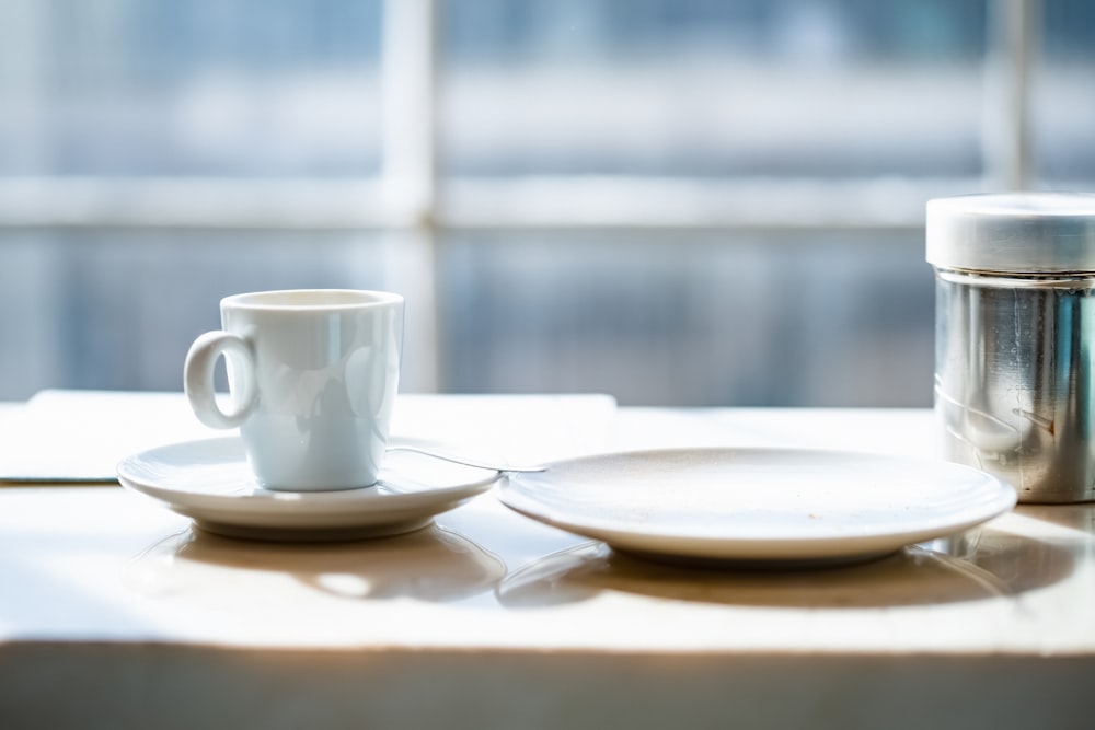 a coffee cup and saucer sitting on a table