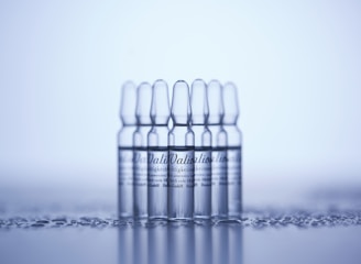 a row of clear bottles sitting on top of a table