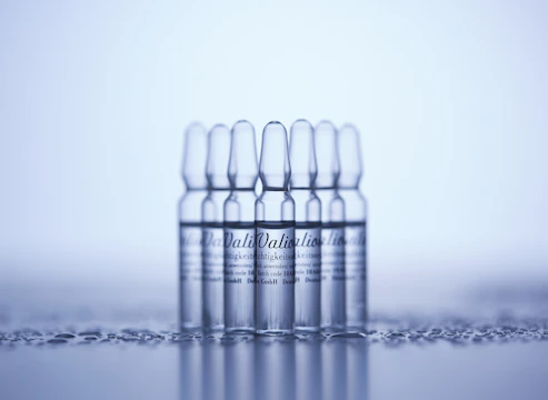a row of clear bottles sitting on top of a table