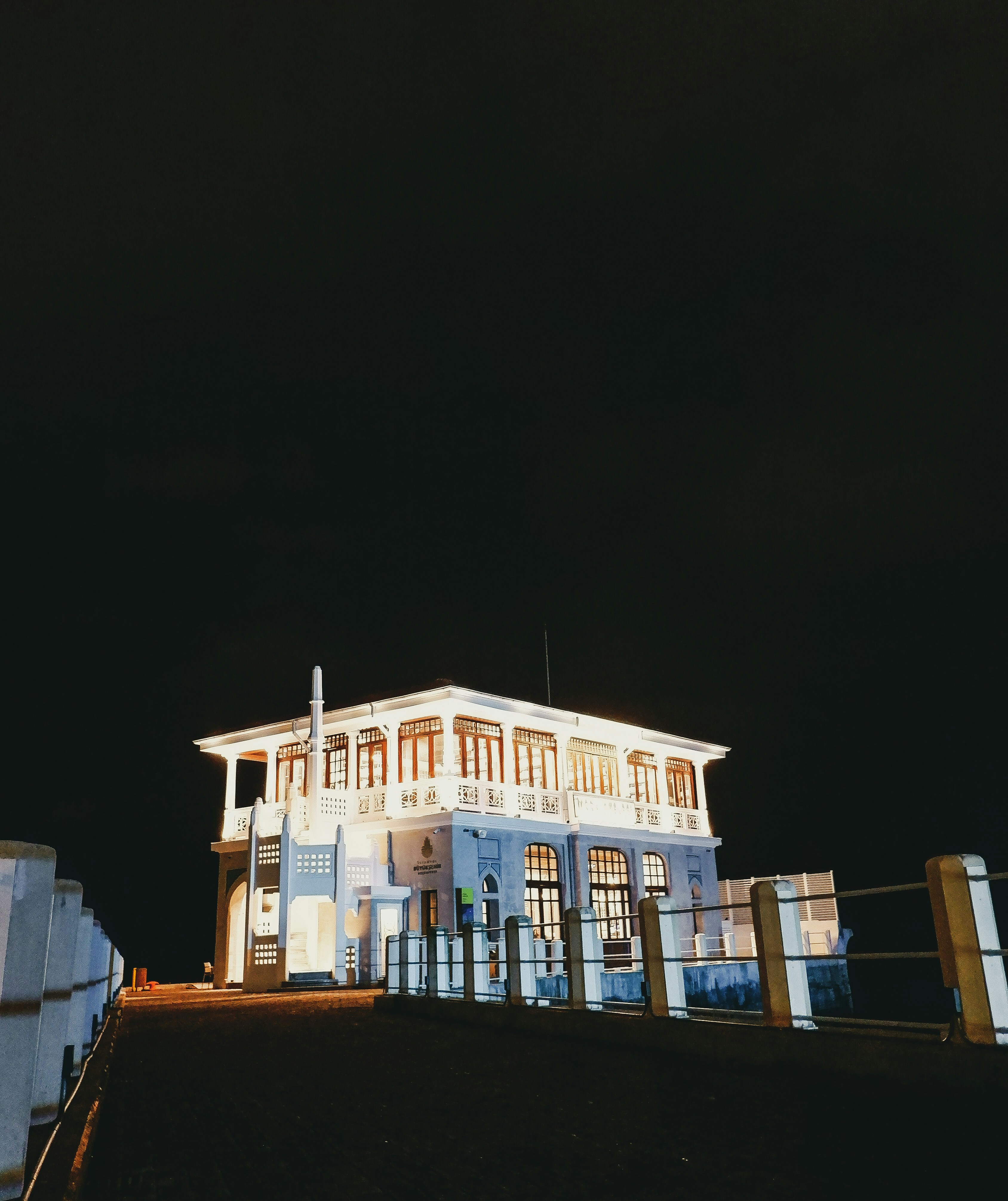 a large white building sitting on top of a hill
