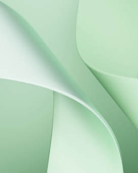 Soft abstract shapes in light green tones create a smooth, flowing pattern with gentle curves and gradients.