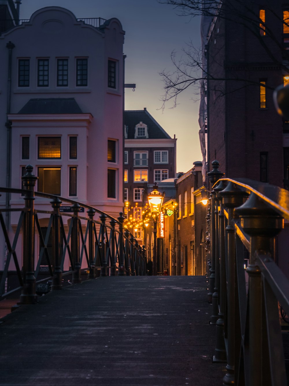 a city street at night with buildings and street lights