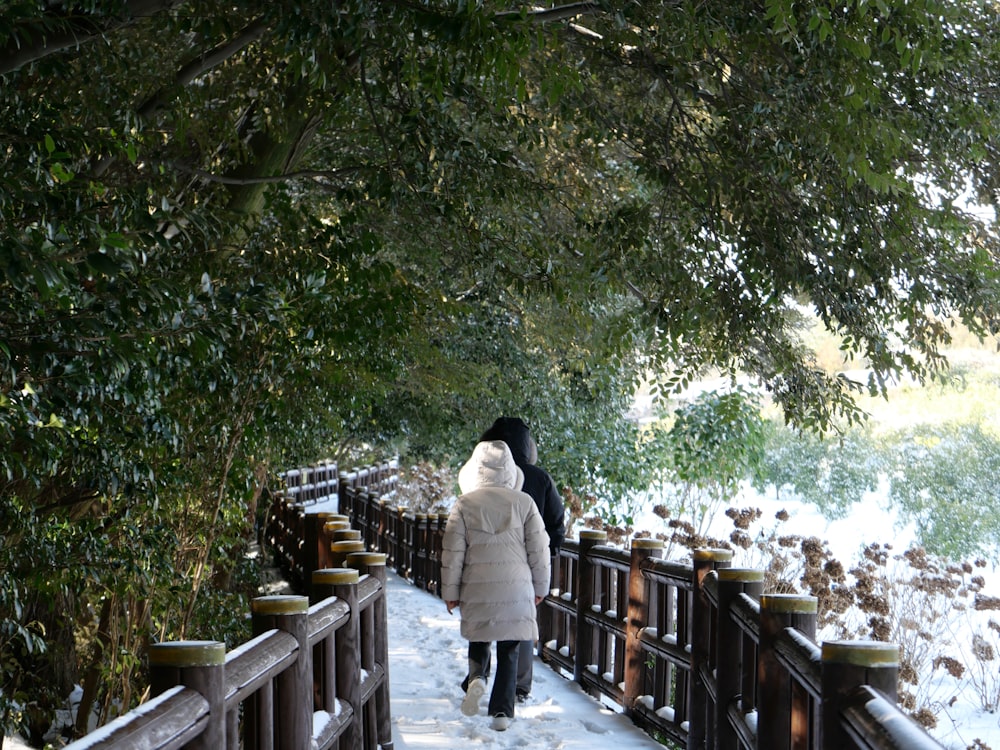 a woman walking down a snow covered walkway
