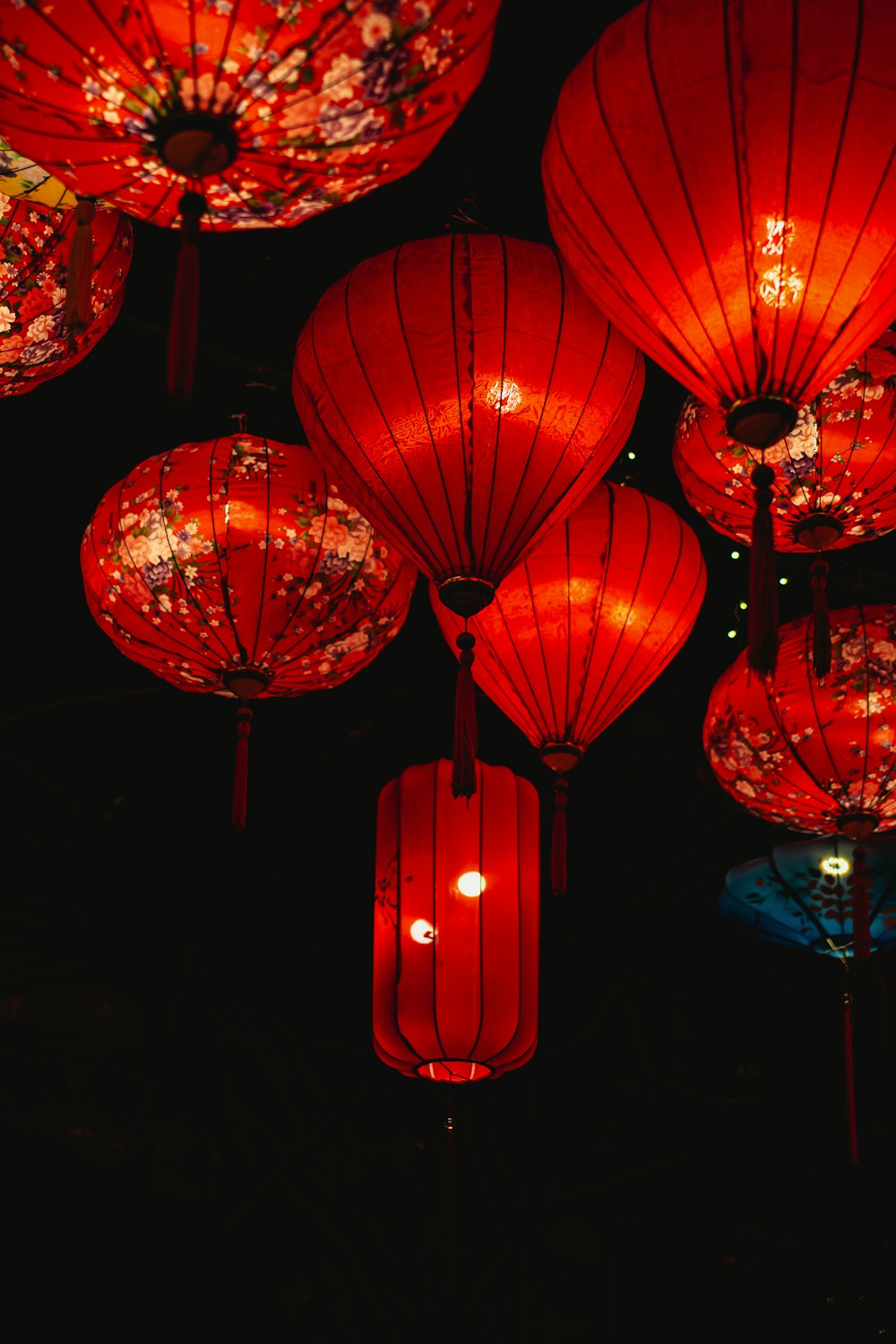Many red lanterns are lit up in the dark photo – Free Lantern Image on  Unsplash