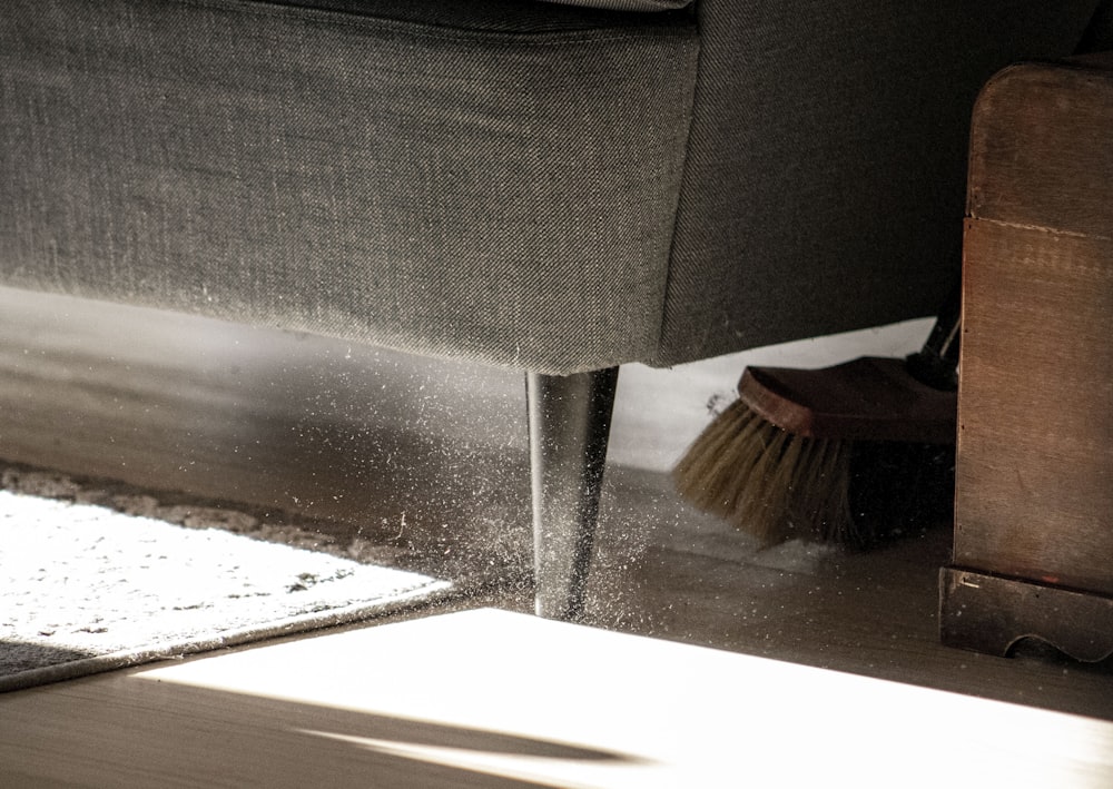 a close up of a chair with a broom on the floor