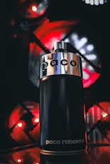 a close up of a bottle of perfume on a table