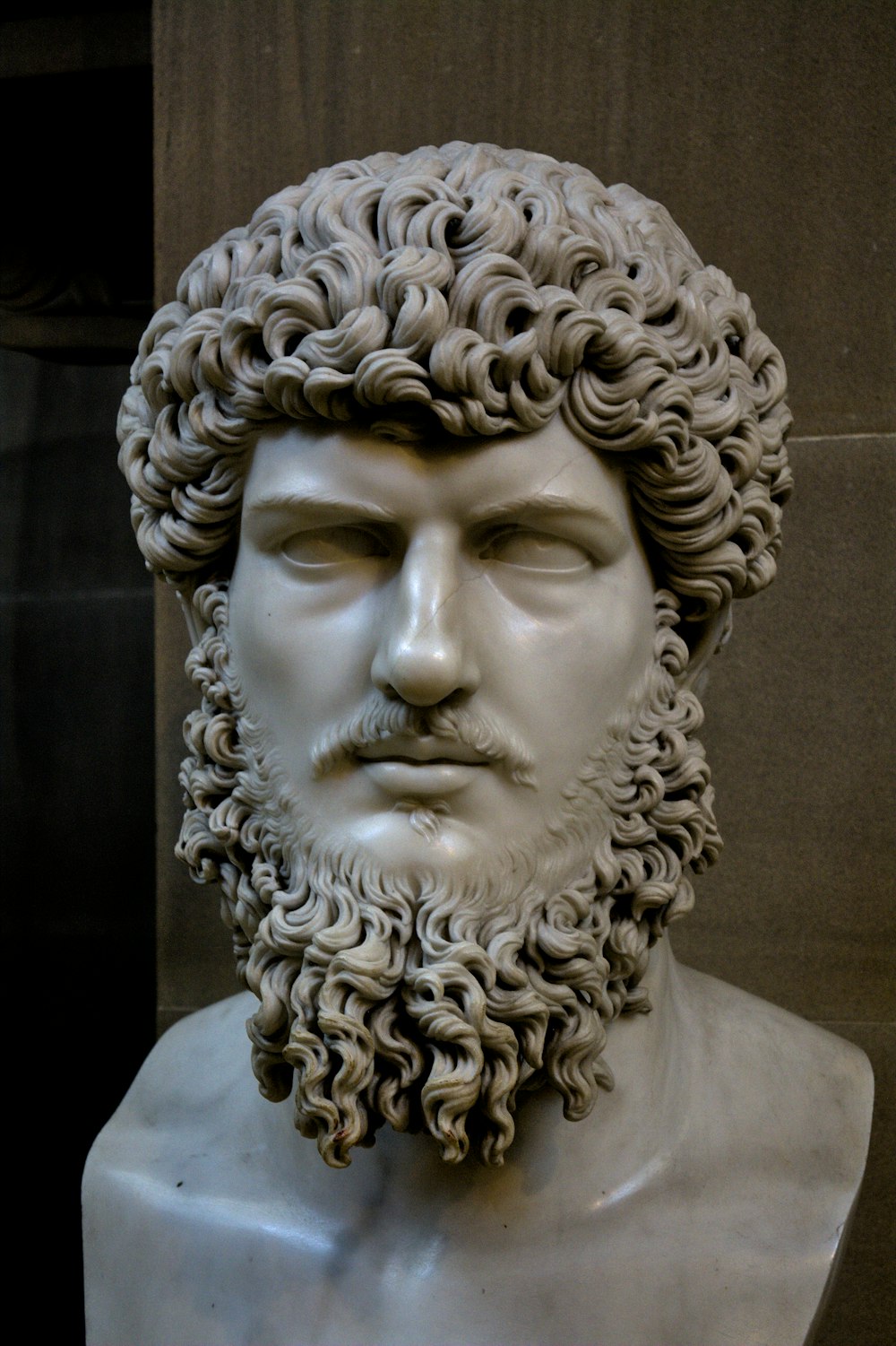 a statue of a man with curly hair and beard