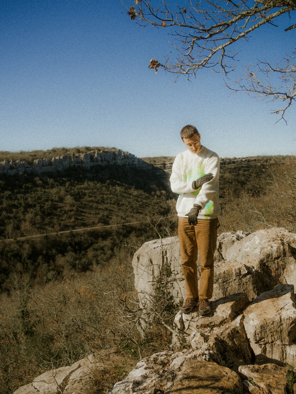 a man standing on top of a large rock