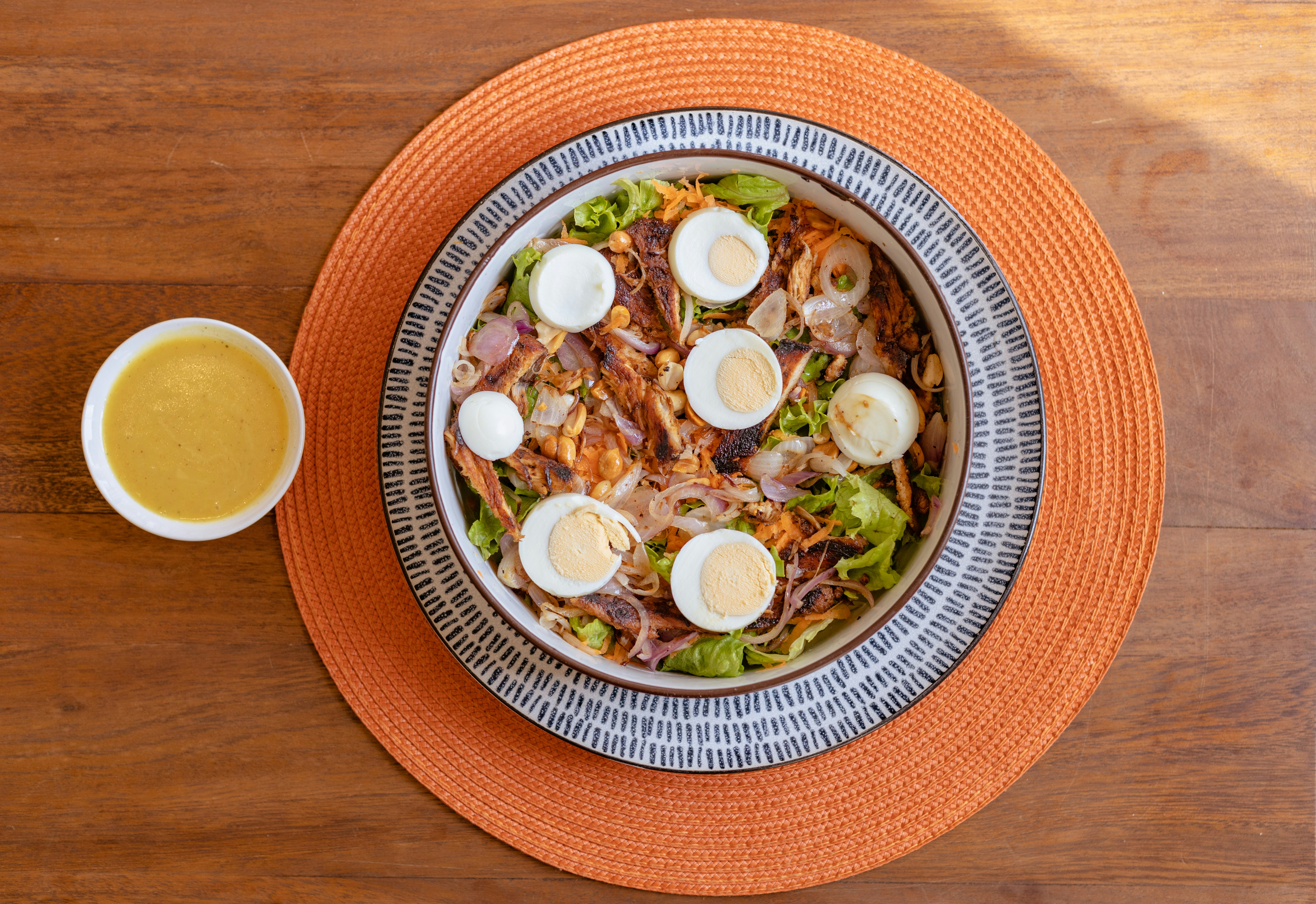 a bowl of salad with hard boiled eggs on top