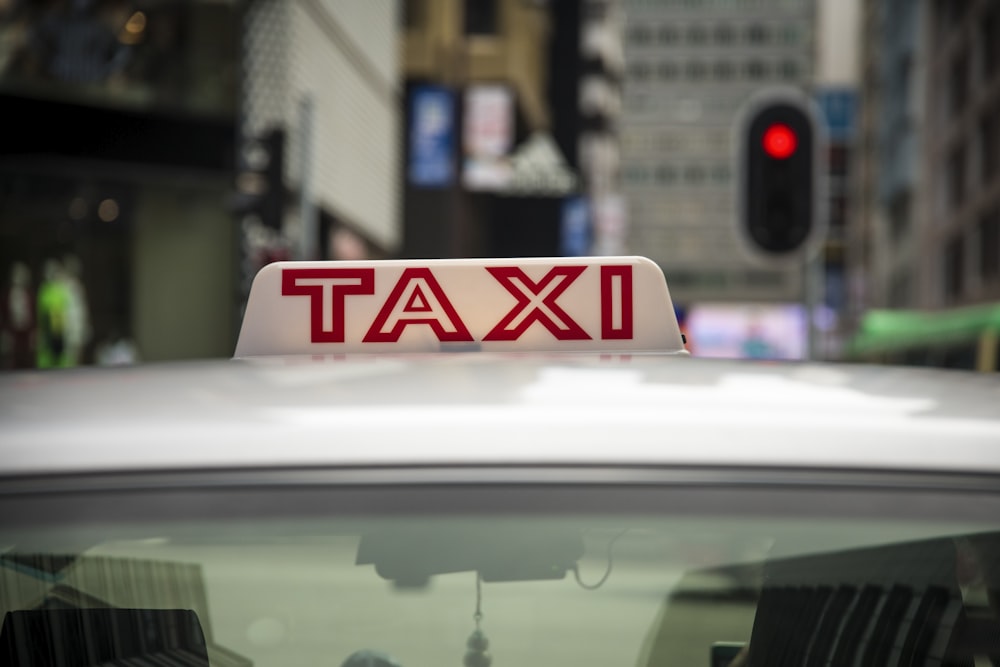 a close up of a taxi sign on the roof of a car