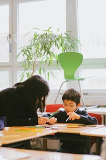 a woman and a child sitting at a table