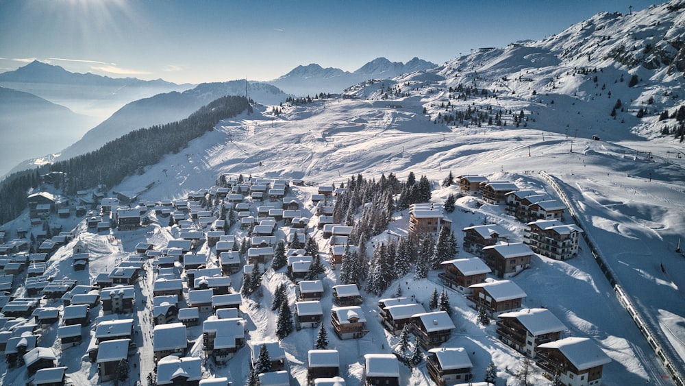 a snow covered mountain with houses on it