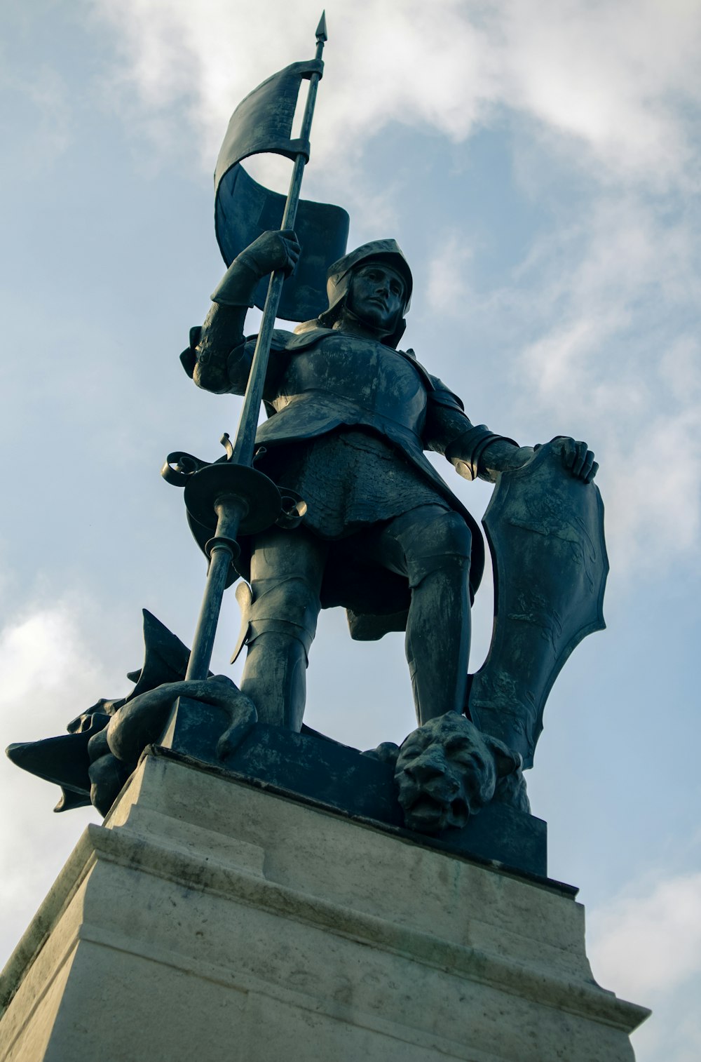 a statue of a man holding a flag