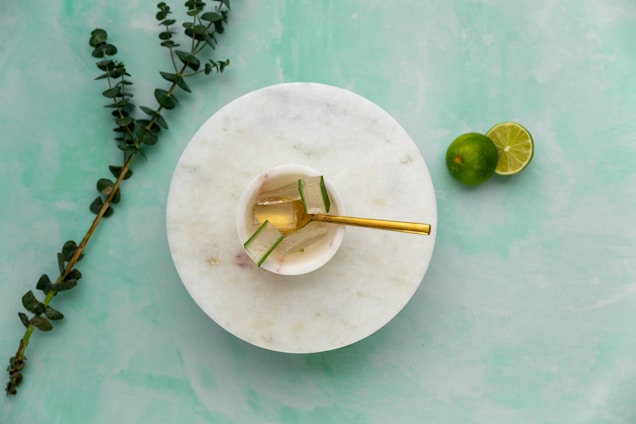a white plate topped with a gold spoon