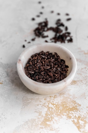 a white bowl filled with chocolate chips on top of a table