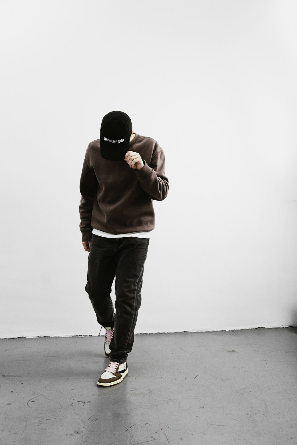 a man in a brown hoodie is walking