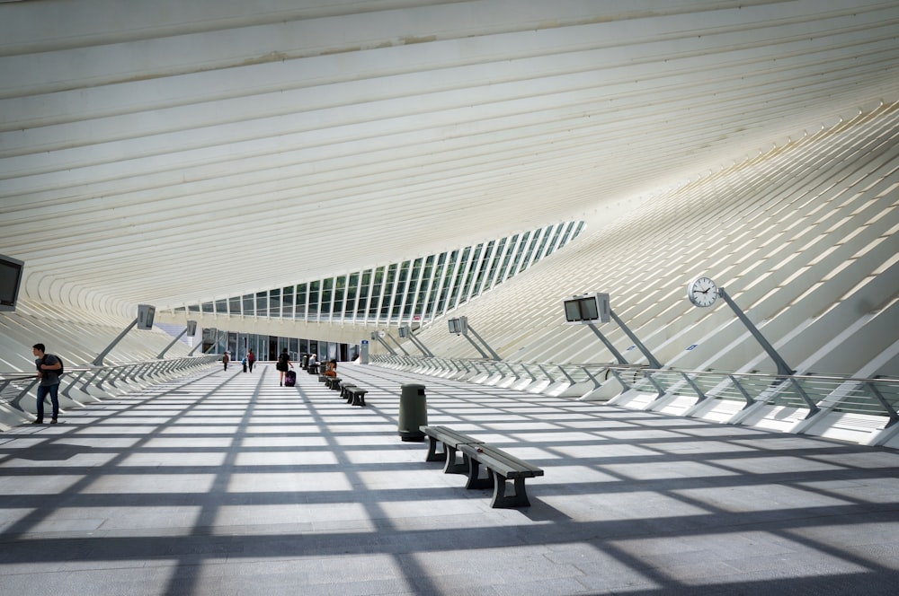 a group of people walking down a long hallway