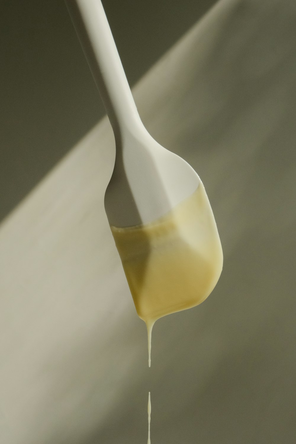 a spoon with liquid pouring out of it