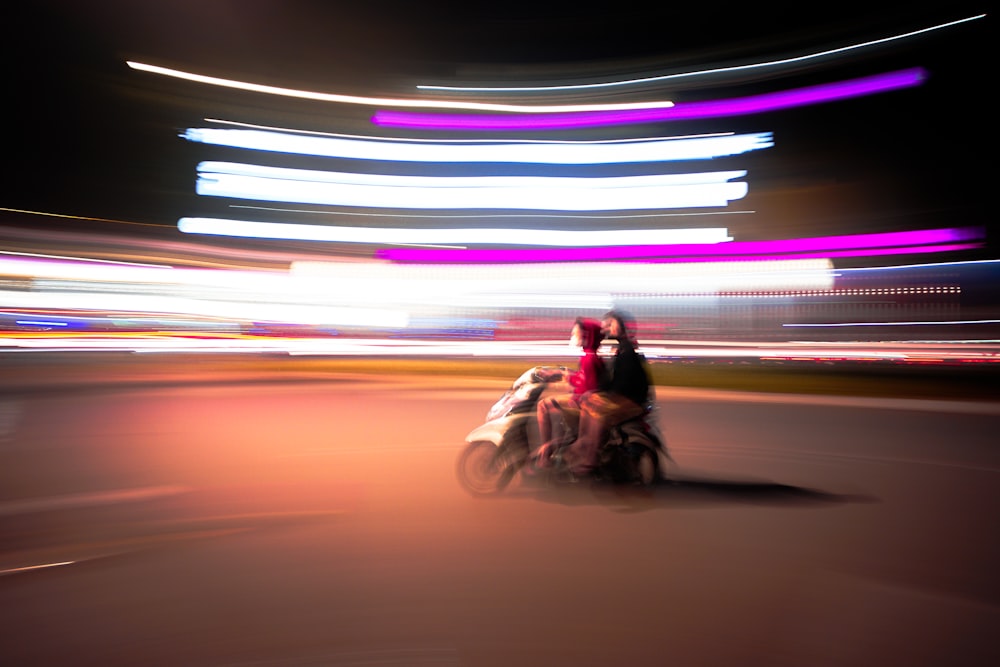 a blurry photo of a person riding a motorcycle