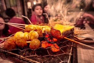Catering team serving delicious grilled dishes at a lively outdoor event.