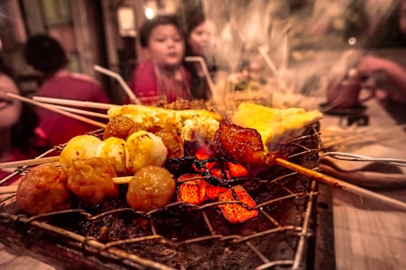 Catering team serving delicious grilled dishes at a lively outdoor event.