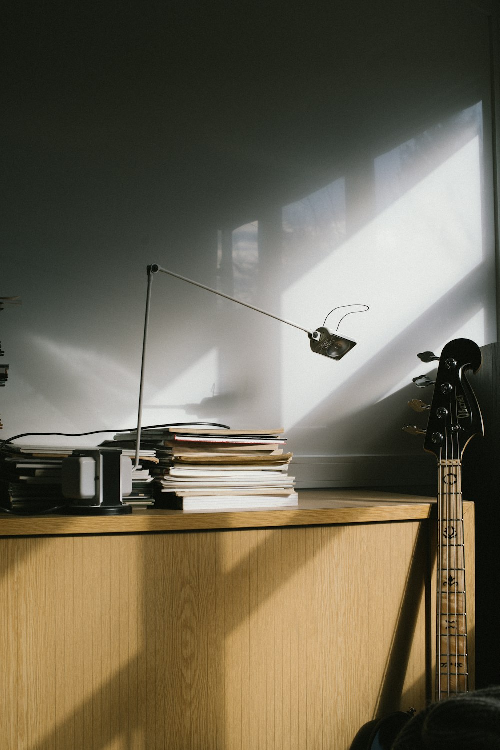 a guitar sitting on top of a wooden desk