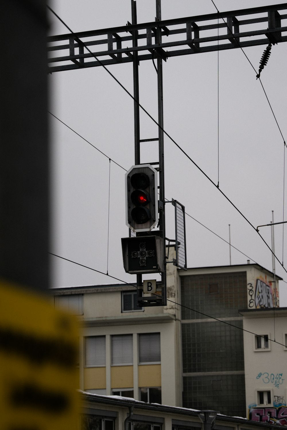 a traffic light hanging from the side of a building