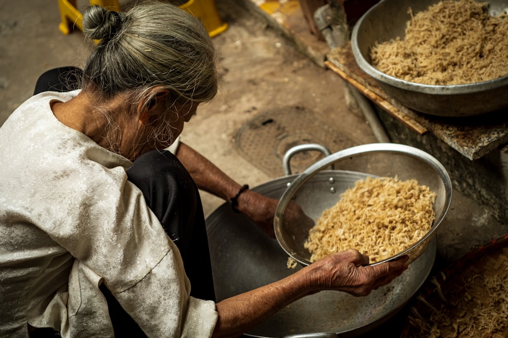 a woman is holding a bowl of food