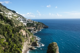 A scenic view of the Amalfi Coast with colorful cliffside villages and azure waters.