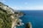 A scenic view of the Amalfi Coast with colorful cliffside villages and a clear blue sky.
