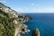 A scenic view of the Amalfi Coast with colorful cliffside villages and a clear blue sky.