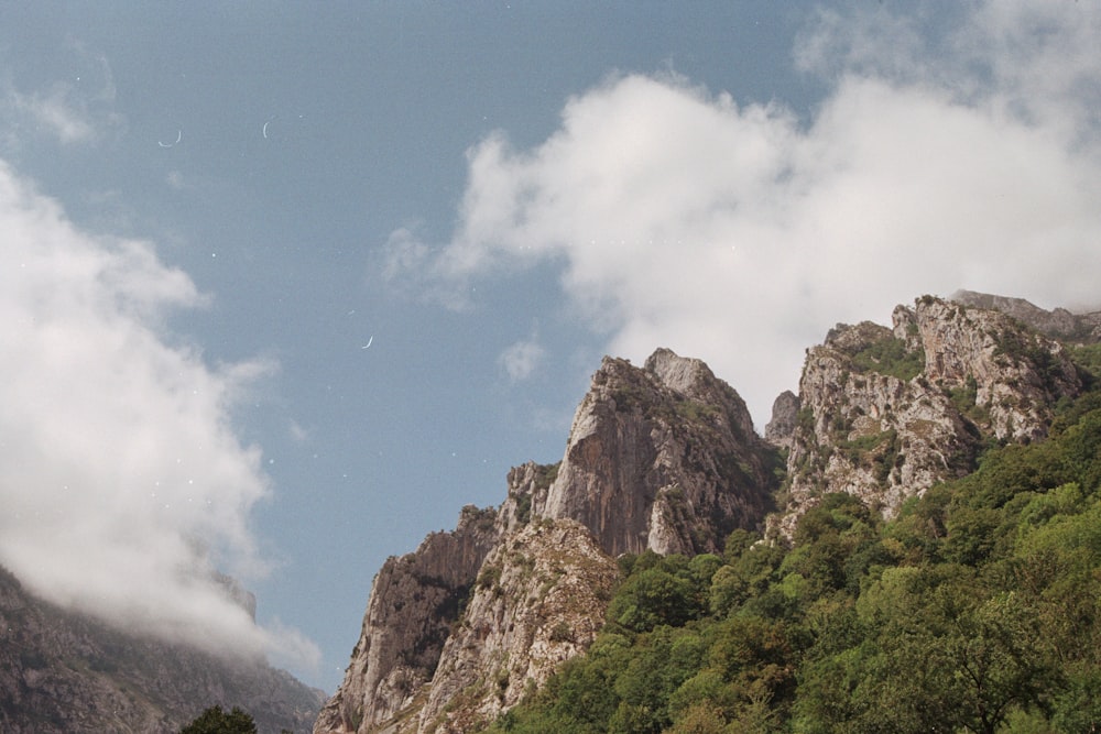 a view of a mountain with a few clouds in the sky