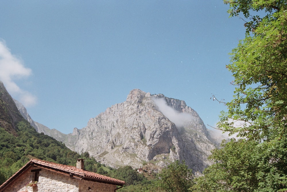 a house with a mountain in the background