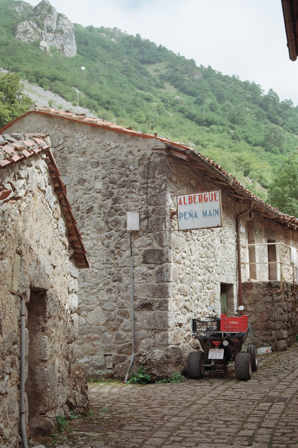 a tractor parked in front of a stone building