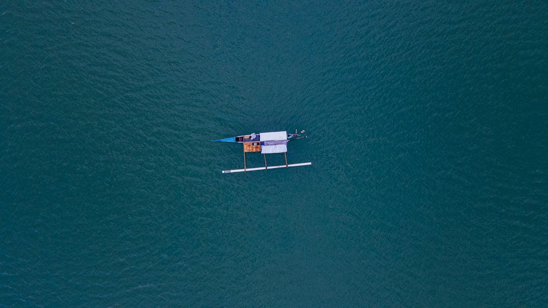 a small boat floating on top of a large body of water