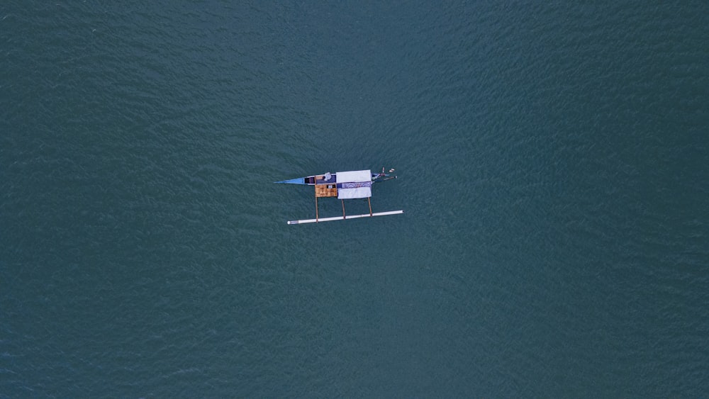 a small boat floating on top of a large body of water