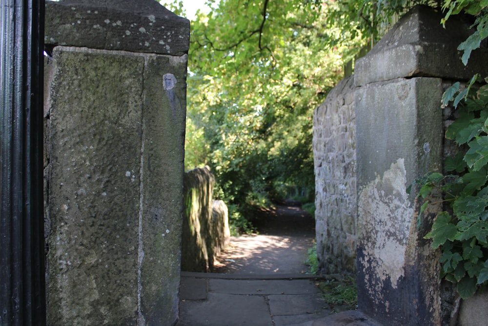 a stone path between two stone pillars